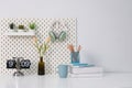 Stylish desk interior with White table background with plant and leaves. Modern home office interior Royalty Free Stock Photo