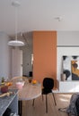 Dining table in apartment with orange wall Royalty Free Stock Photo
