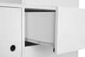 Stylish dresser with open drawer on white background, closeup.