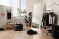 Stylish dressing room interior with trendy clothes and shoes Royalty Free Stock Photo