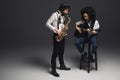 stylish duet of musicians playing sax and acoustic guitar