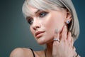 Stylish earring on the ear of the model. Macro studio portrait of a woman and decorations