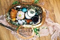 Stylish Easter basket with modern eggs, easter bread cake, ham, beets, sausage, butter and green branches on rustic fabric with Royalty Free Stock Photo