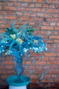 Stylish easter bouquet in blue tones over brick wall background, selective focus, copy space Royalty Free Stock Photo