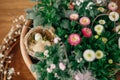 Stylish easter eggs with feather in nest and potted spring flowers composition top view on table. Happy Easter! Simple easter Royalty Free Stock Photo