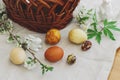 Stylish easter eggs, wicker basket, bunny and spring blooming flowers anemones on rustic table