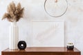 Stylish and eclectic interior of living room with design retro cabinet, round pendant lamp, marble cubes and elegant accessories.