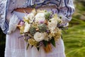 Stylish eclectic wedding bouquet in the bride hands