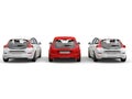 Stylish eco friendly modern cars - red stands out in the middle - back view