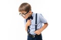 Stylish educated boy in glasses and a classic suit proves something on a white background Royalty Free Stock Photo