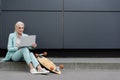 stylish elderly businesswoman sitting on border