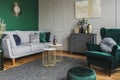 Stylish emerald green and grey living room interior design with abstract painting on the wall Royalty Free Stock Photo