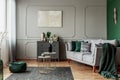 Stylish emerald green and grey living room interior design with abstract painting on the wall Royalty Free Stock Photo