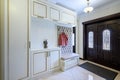 Stylish entrance hall with closet, storage bench and hanger stand