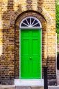 stylish entrance to a residential building, an interesting facade of the old brick arches above the door, a typical old English b