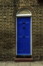 stylish entrance to a residential building, an interesting facade of the old brick arches above the door, a typical old English b