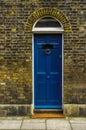 stylish entrance to a residential building, an interesting facade of the old brick arches above the door, a typical old English b