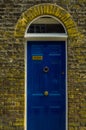 stylish entrance to a residential building, an interesting facade of the old brick arches above the door, a typical old English b