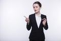 Stylish expressive young girl with long hair in a dark business suit and a white shirt