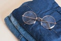 stylish eye glasses on a stack of jeans Royalty Free Stock Photo