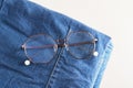 stylish eye glasses on a stack of jeans Royalty Free Stock Photo