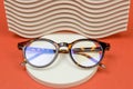 Stylish eyeglasses on a round podium