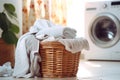 Stylish fabric care: a high-tech washing machine paired with a wicker laundry basket