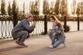 Stylish family dressed in denim clothes walks near the river and has fun blowing bubbles Royalty Free Stock Photo