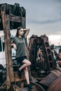 Stylish fashion portrait of trendy casual young model on a metal rusty detail