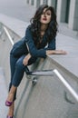 Stylish fashionable brunette in a blue suit in the city. Fashion photo Royalty Free Stock Photo