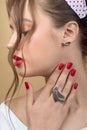 Stylish fashionable girl wears authentic accessories: silver ring and bird-shaped earrings, women`s fashion, beauty, advertising