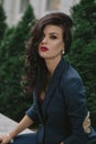 Stylish fashionable brunette in blue suit in the city. Fashion photo Royalty Free Stock Photo