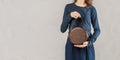 Stylish fashionable woman with brown round bag