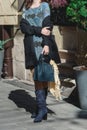 Stylish fashionable woman in dark blue suede boots and dress. Girl in winter boots with leather bag on the street Royalty Free Stock Photo