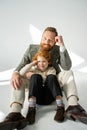 Stylish father and redhead son posing