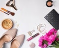 Stylish feminine accessories, cosmetics and pink peonies on the Royalty Free Stock Photo