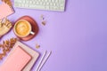 Stylish feminine office desk table with coffee cup, notebook and computer keyboard. Top view, flat lay