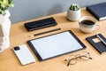 Stylish flat lay business composition on the wooden desk with mock up tablet, cacti, notes, photo camera and office supplies . Royalty Free Stock Photo