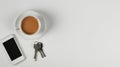 Stylish flat view of neat table arrangement displaying phone, coffee cup, hands, keys