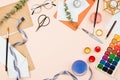 Stylish flatlay with art supplies, envelopes, brushes, watercolors, glasses, pen and other stationary and art supplies