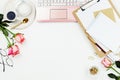 Stylish flatlay frame arrangement with pink laptop, candles, roses, glasses and other accessories