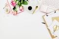 Stylish flatlay frame arrangement with pink laptop, roses, glasses and other accessories on white