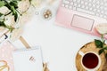 Stylish flatlay frame arrangement with pink laptop, tea, roses, glasses and other accessories on white