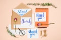 Stylish flatlay with vintage envelopes and handmade cards with handlettering thank you, dried roses, scissors and pen, pastel back Royalty Free Stock Photo