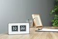 Stylish flip clock on table in office, space for text.