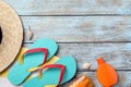 Stylish flip flops and beach objects on light wooden background, flat lay. Space for text Royalty Free Stock Photo