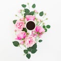 Stylish floral composition made of pink roses, buds and mug of black coffee on white background. Flat lay, Top view. Royalty Free Stock Photo