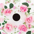 Stylish floral composition made of pink roses, buds and mug of coffee on white background. Flat lay, Top view. Royalty Free Stock Photo