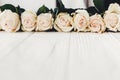 Stylish Floral greeting card mockup. White roses on wooden background, copy space for text. Wedding invitation or happy mother da Royalty Free Stock Photo