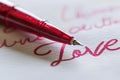 A stylish fountain pen elegantly placed on a pristine sheet of paper, written "love" Royalty Free Stock Photo